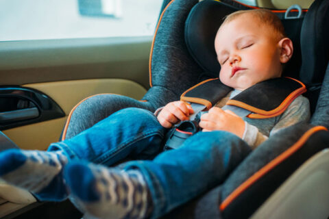 a child sleeping in a car
