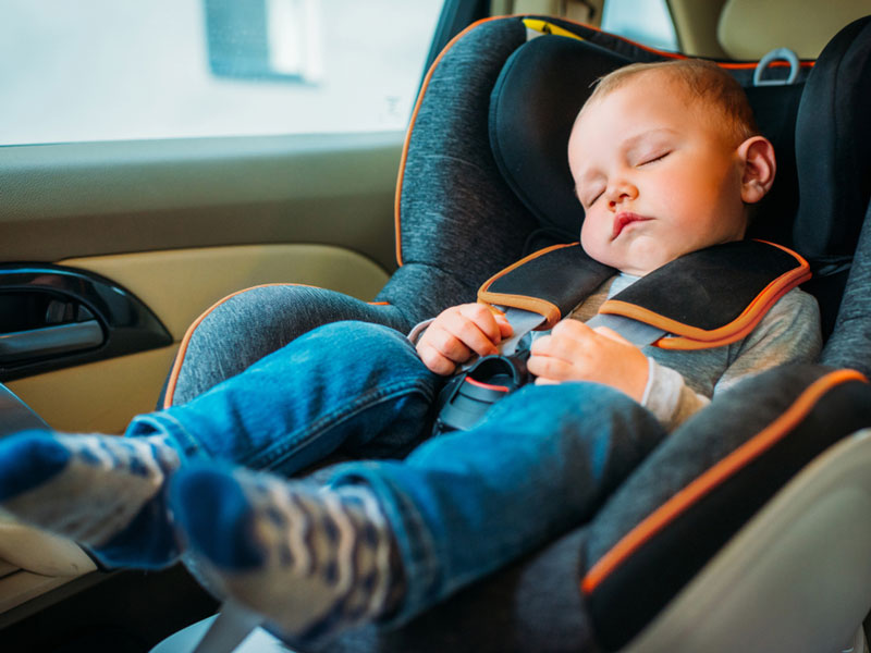 a child sleeping in a car
