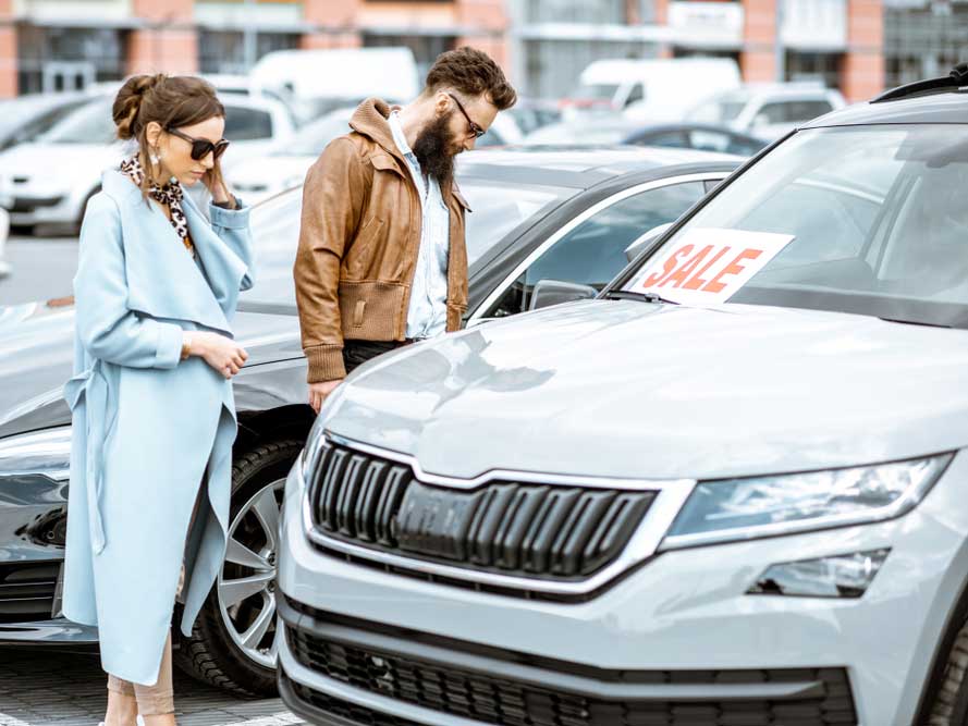 man and woman looking for car sales