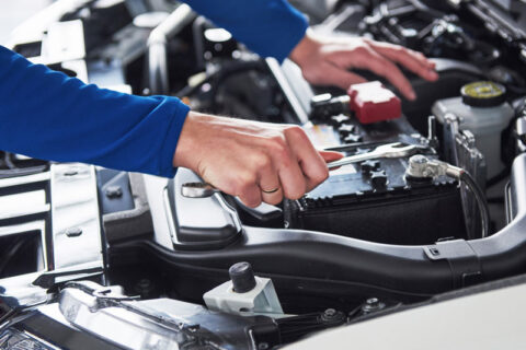 man servicing a car