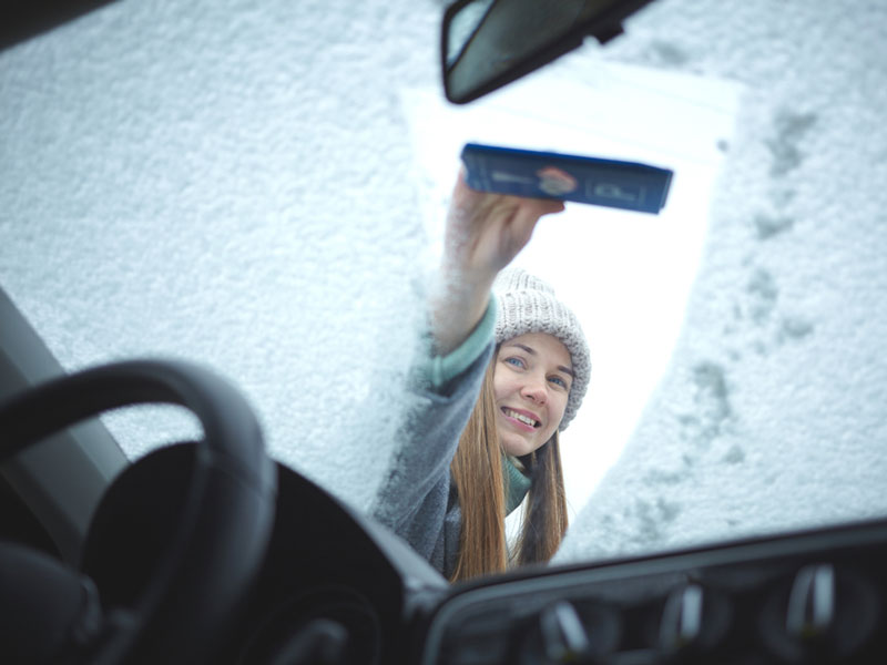 car front glass is being cleaned with paper