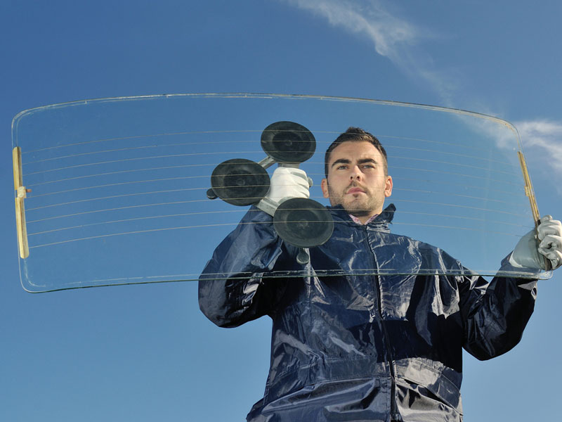 a man placing a windsheild