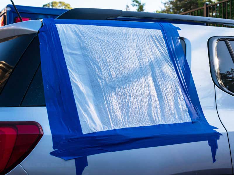 car window covered with plastic 