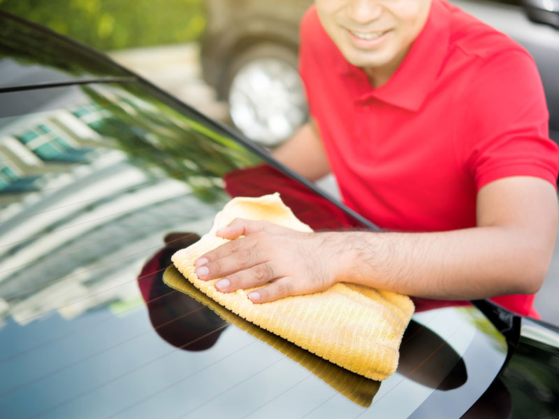 Man Cleaning Car Windshield in Las Vegas, NV